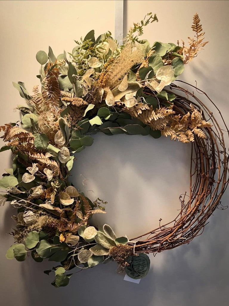 Eucalyptus, fern, and lunaria wreath on a grapevine base
